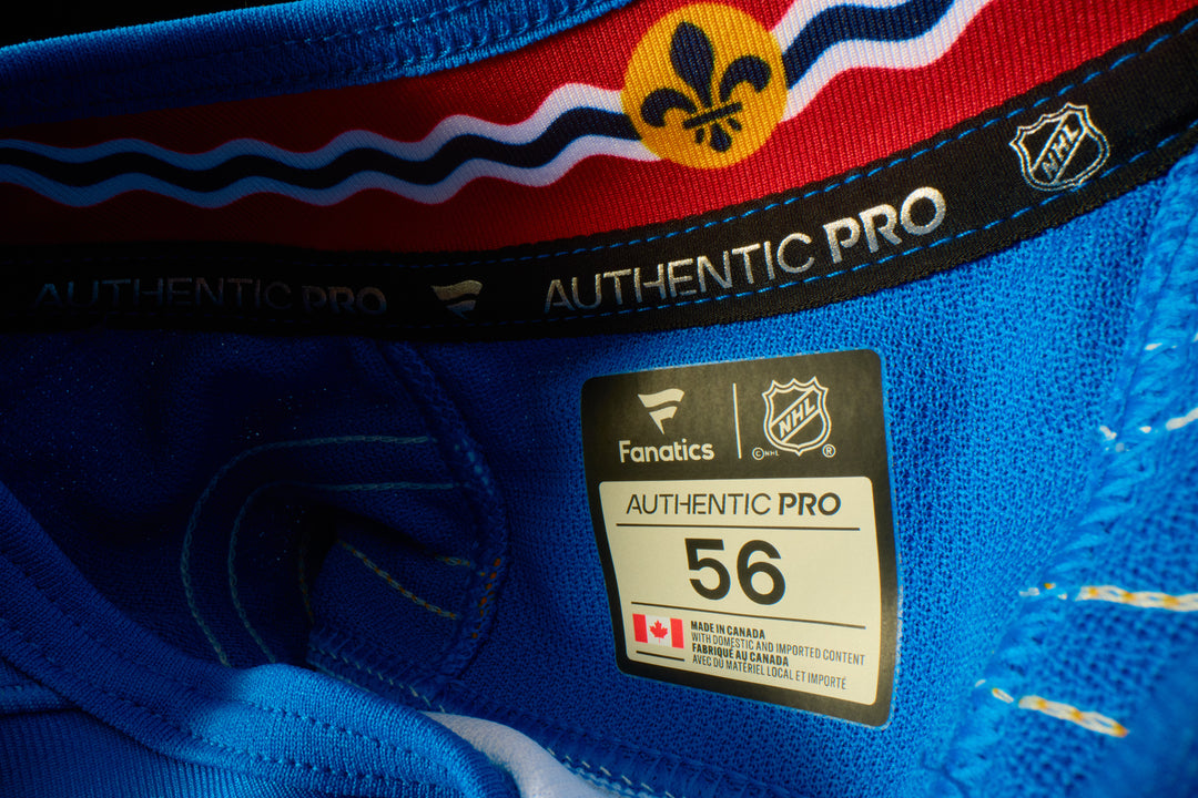 Close-up of a blue sports jersey with 'Authentic Pro' label and number 56.