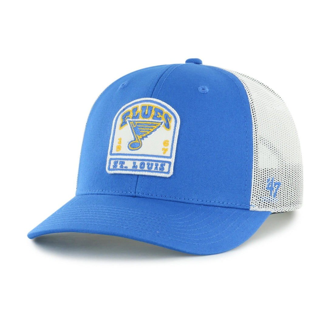 A blue and white St. Louis Blues trucker hat by '47, featuring a blue front panel and brim, white mesh back panels